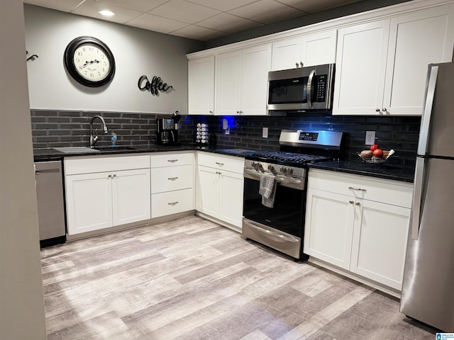 kitchen featuring stainless steel appliances, white cabinets, and sink