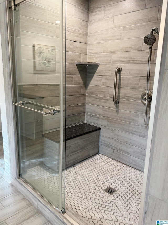 bathroom featuring a shower with door