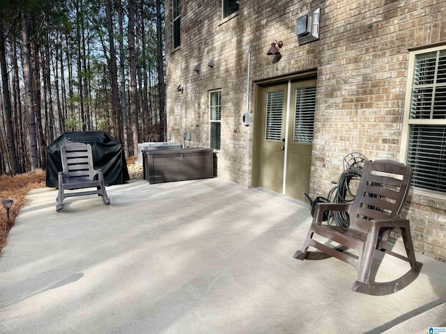 view of patio with a hot tub and area for grilling