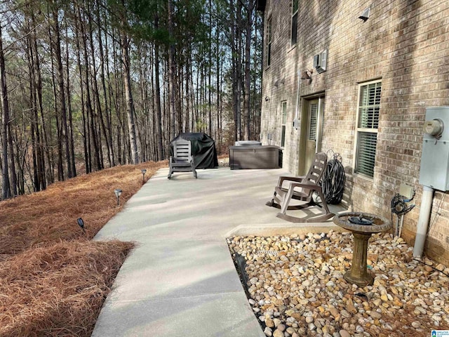 view of patio with a jacuzzi and area for grilling