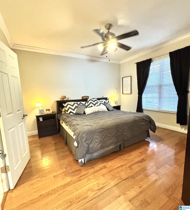 bedroom with ceiling fan, light hardwood / wood-style floors, and crown molding