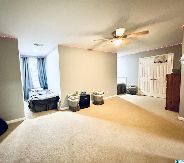 interior space featuring a textured ceiling, ceiling fan, and carpet floors