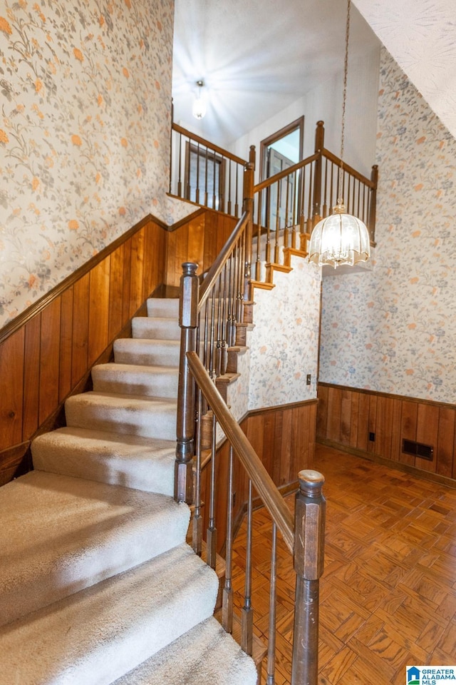 staircase featuring parquet floors