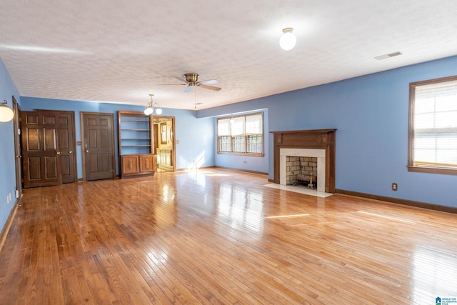 unfurnished living room featuring light hardwood / wood-style floors, a textured ceiling, and ceiling fan