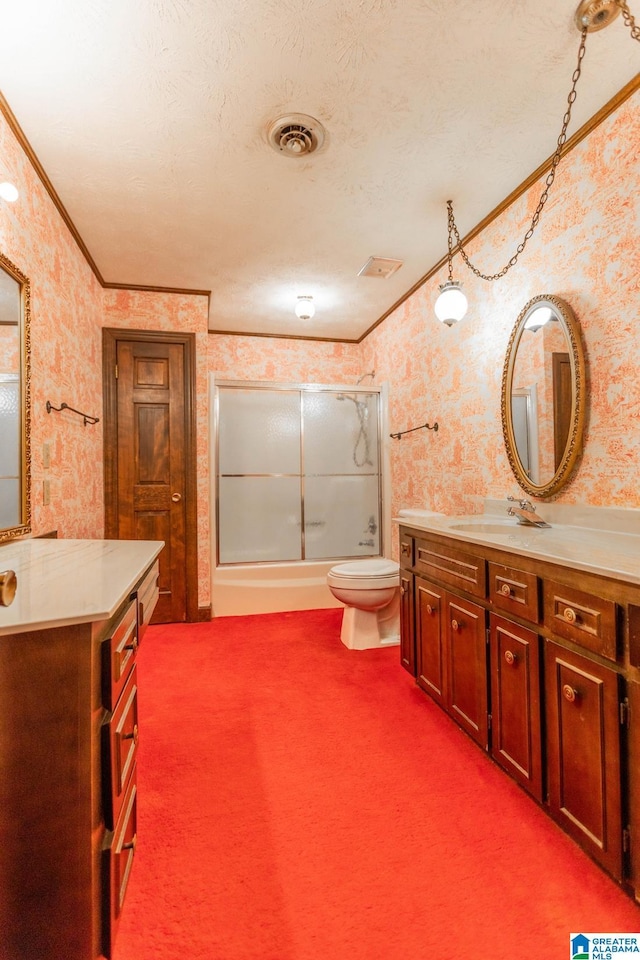 full bathroom featuring toilet, combined bath / shower with glass door, a textured ceiling, crown molding, and vanity