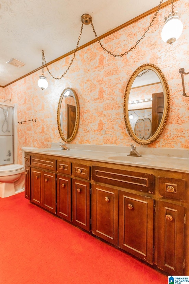 bathroom featuring toilet, crown molding, and vanity