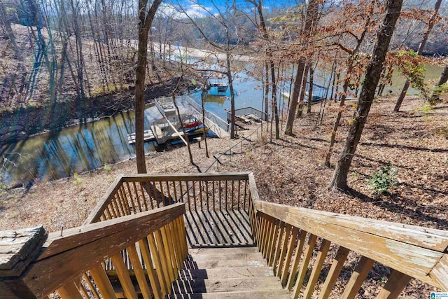 wooden deck with a water view and a dock