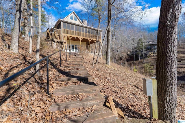 view of front of home featuring a wooden deck and a sunroom