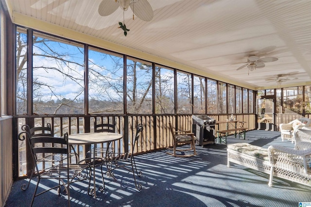 sunroom / solarium featuring ceiling fan