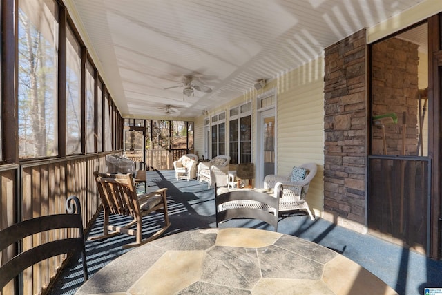 sunroom / solarium featuring ceiling fan and a healthy amount of sunlight