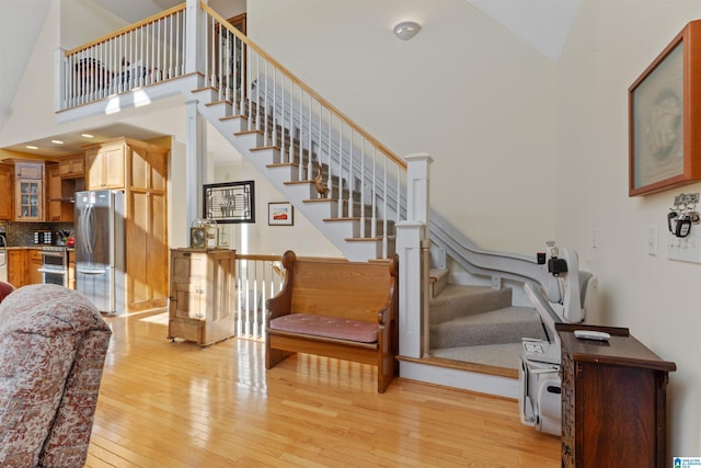 interior space featuring hardwood / wood-style flooring and high vaulted ceiling