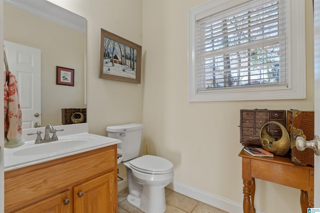 bathroom with tile patterned floors, vanity, crown molding, and toilet