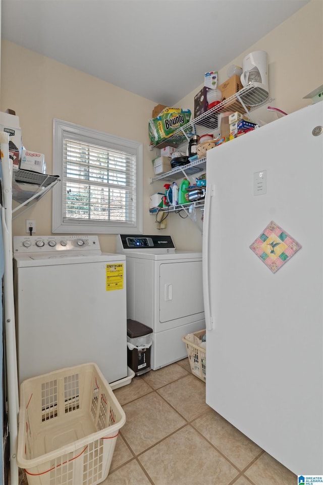 washroom with separate washer and dryer and light tile patterned floors