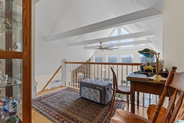 living area featuring ceiling fan, wood-type flooring, and lofted ceiling with beams