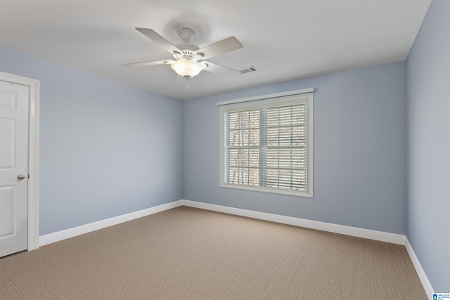 empty room with ceiling fan and carpet