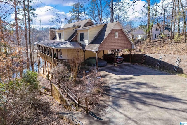 view of property exterior with a porch and a carport