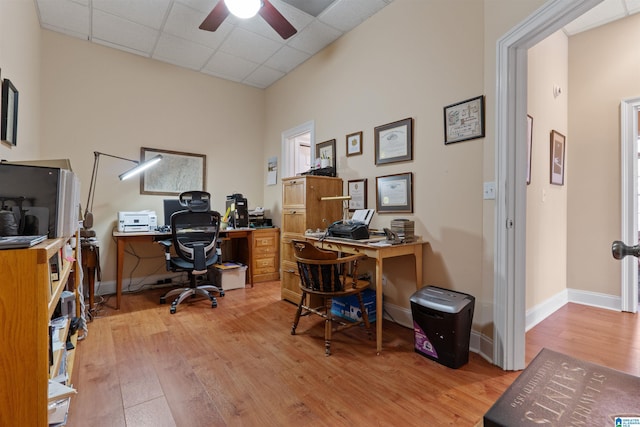 office area with ceiling fan, hardwood / wood-style floors, and a paneled ceiling