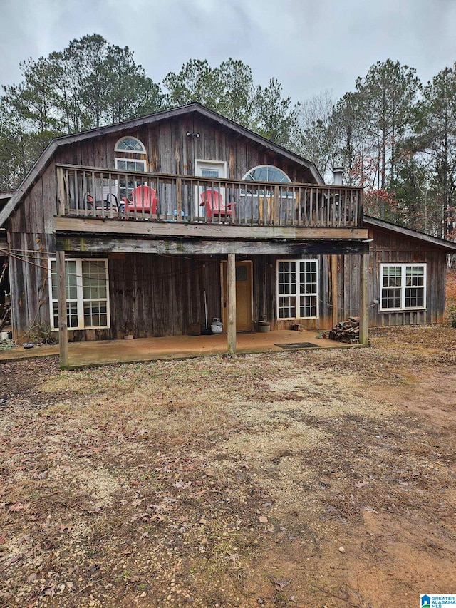 back of property featuring a deck