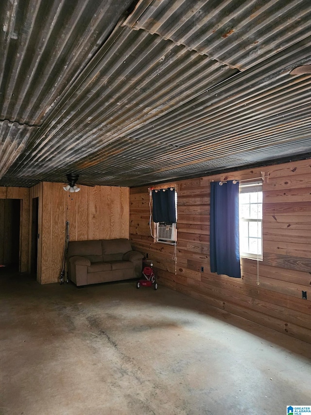 basement featuring cooling unit and wood walls