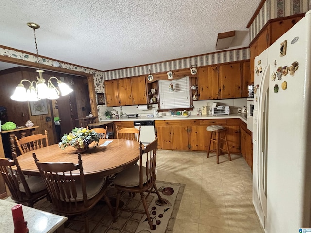 dining room with sink, a chandelier, and a textured ceiling