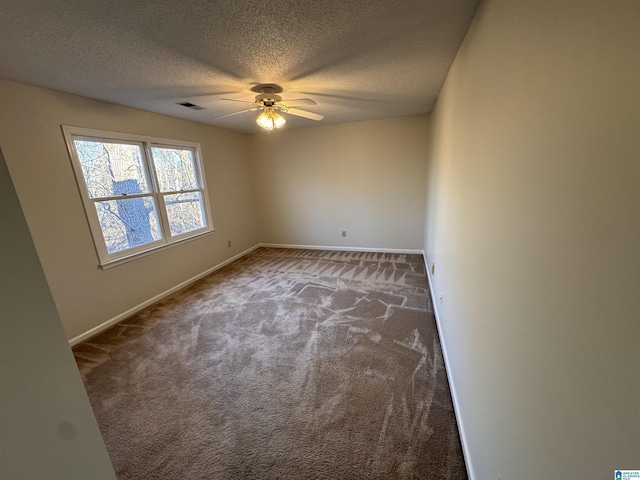 carpeted empty room featuring a textured ceiling and ceiling fan