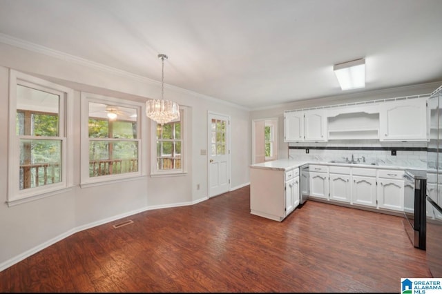 kitchen with white cabinets, appliances with stainless steel finishes, decorative light fixtures, tasteful backsplash, and sink