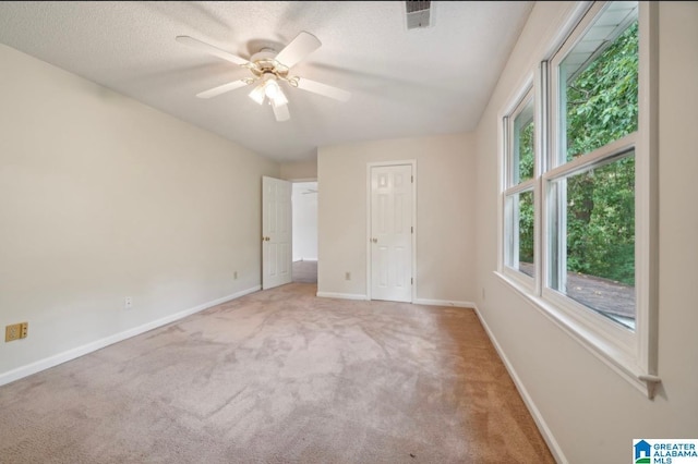 unfurnished bedroom featuring a textured ceiling, ceiling fan, and carpet flooring