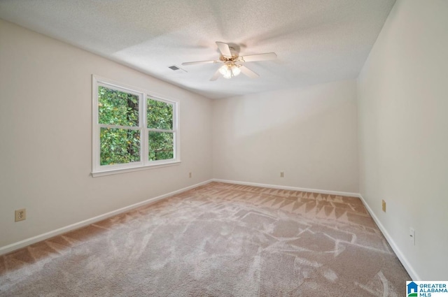 carpeted spare room with ceiling fan and a textured ceiling