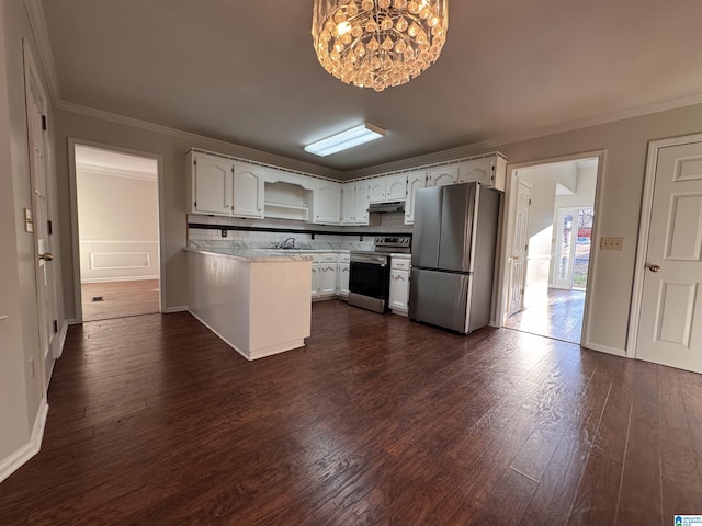 kitchen featuring decorative backsplash, sink, white cabinetry, stainless steel appliances, and a chandelier