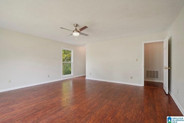 spare room featuring ceiling fan, dark hardwood / wood-style floors, and a textured ceiling