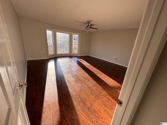 unfurnished room with a textured ceiling, ceiling fan, and hardwood / wood-style flooring