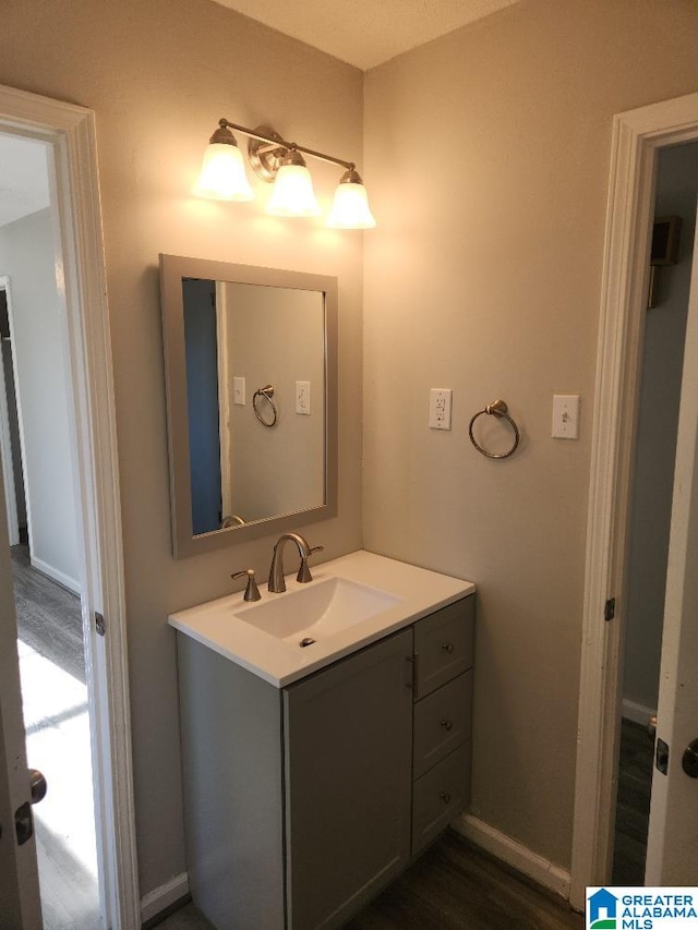 bathroom with hardwood / wood-style flooring and vanity