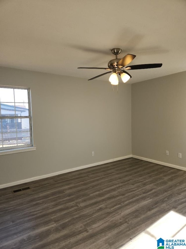 unfurnished room with ceiling fan and dark hardwood / wood-style floors