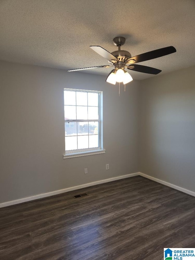 spare room featuring a textured ceiling, dark hardwood / wood-style floors, and ceiling fan