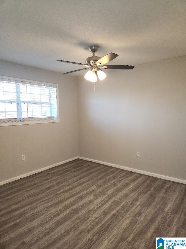 empty room featuring dark hardwood / wood-style floors and ceiling fan