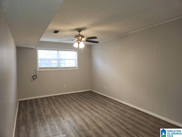 unfurnished room with ceiling fan and dark hardwood / wood-style flooring