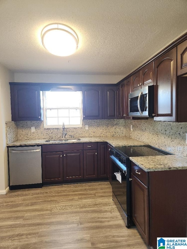 kitchen with sink, stainless steel appliances, and dark brown cabinetry