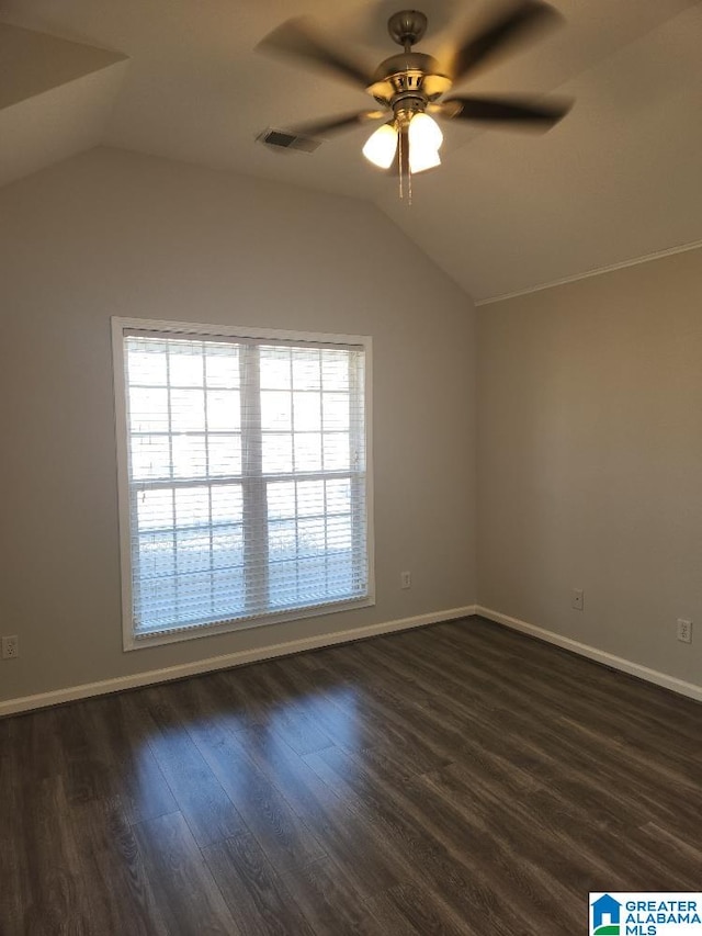 empty room featuring ceiling fan, dark wood-type flooring, and lofted ceiling