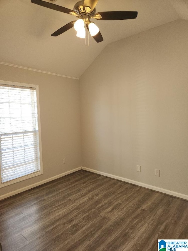 empty room with vaulted ceiling, ceiling fan, and dark hardwood / wood-style floors