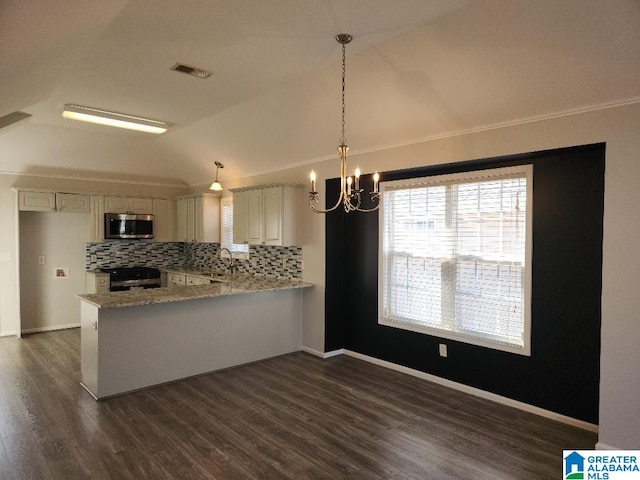 kitchen featuring kitchen peninsula, decorative light fixtures, backsplash, black stove, and light stone counters