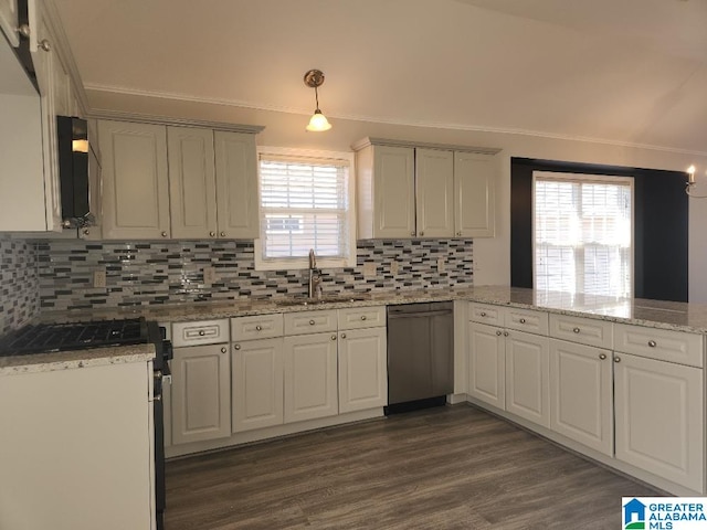 kitchen with sink, kitchen peninsula, appliances with stainless steel finishes, and decorative backsplash