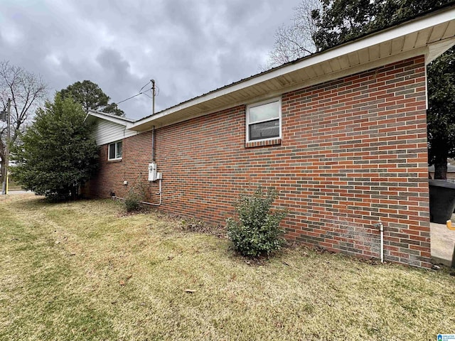 view of side of home featuring a yard