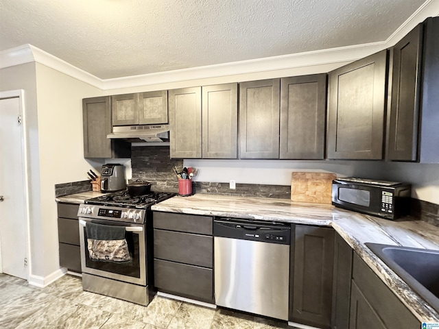 kitchen with decorative backsplash, appliances with stainless steel finishes, crown molding, and a textured ceiling