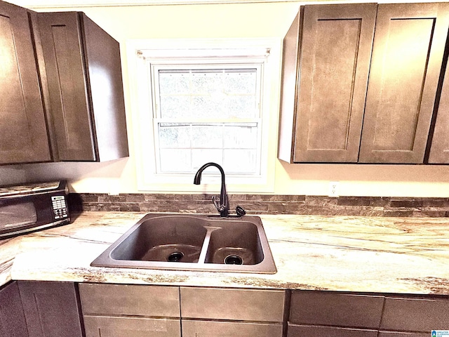 kitchen featuring dark brown cabinetry and sink