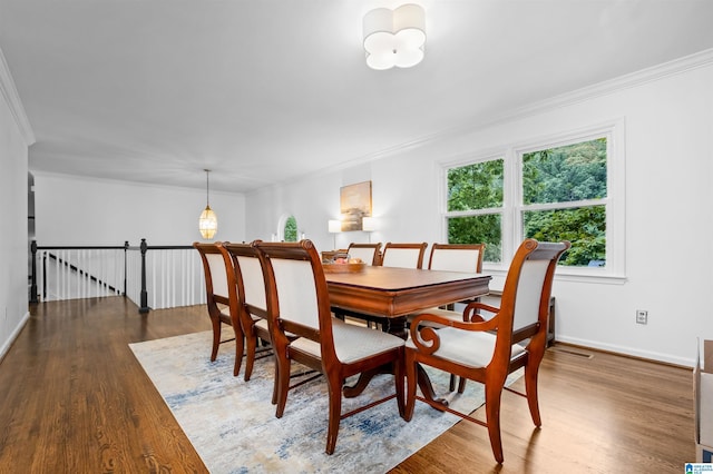 dining room featuring dark hardwood / wood-style flooring and crown molding