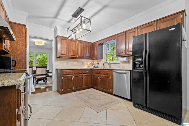 kitchen with a wealth of natural light, dishwasher, black refrigerator with ice dispenser, decorative light fixtures, and light tile patterned floors