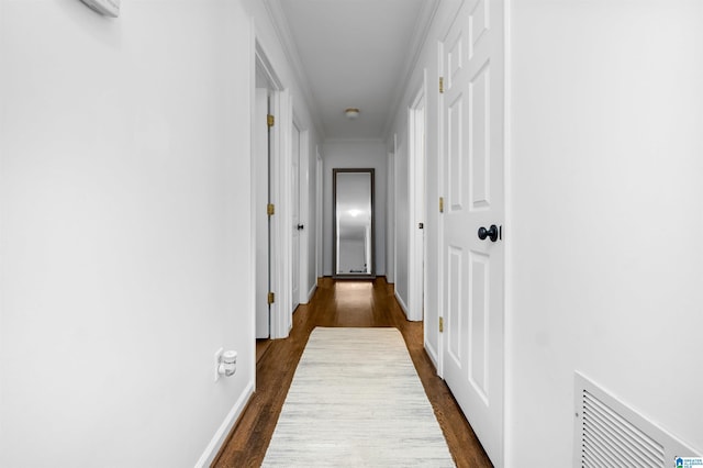 hall with dark hardwood / wood-style floors and ornamental molding