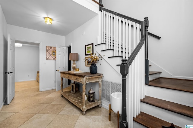 staircase featuring tile patterned floors