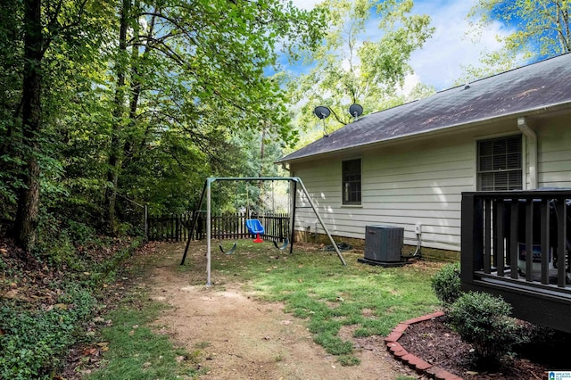 view of yard featuring a playground and central air condition unit