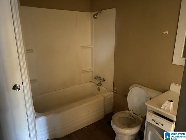 full bathroom featuring shower / bathing tub combination, hardwood / wood-style floors, toilet, and vanity